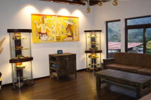 a living room with a couch and a table at Casa Don Cristóbal Hotel y Restaurante Boutique in San Juan La Laguna