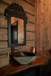 a bathroom with a stone sink and a mirror at Hylja Lodge in Vaga
