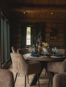a dining room with a table with glasses and chairs at Hylja Lodge in Vaga