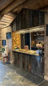 a kitchen with a wooden counter with flowers on it at Hylja Lodge in Vaga