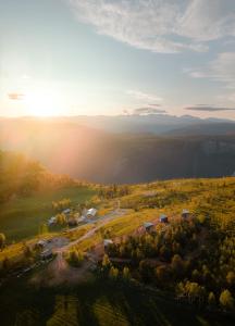 an aerial view of a farm with the sun setting at Hylja Lodge in Vaga +15 photos