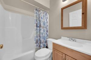 a bathroom with a toilet and a sink and a mirror at Between Tides 2BR Walk to Beach Unit B in Seaside Park