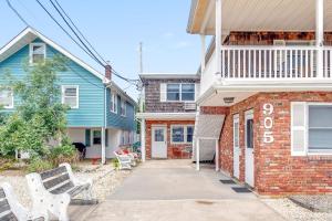 a brick house with a bench in front of it at Between Tides 2BR Walk to Beach Unit B in Seaside Park
