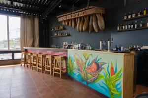a bar with a colorful mural on the wall at Casa Don Cristóbal Hotel y Restaurante Boutique in San Juan La Laguna