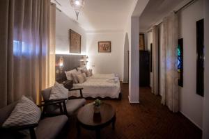 a living room with a bed and a couch at Casa Bellavista Chaouen in Chefchaouen