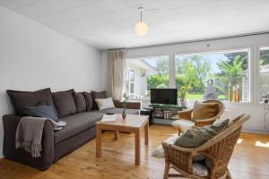 a living room with a couch and a table at SL364-Slagelse-Hirsevangen-4 in Strandlyst