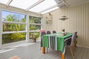 a dining room with a table and some windows at SL364-Slagelse-Hirsevangen-4 in Strandlyst +17 photos