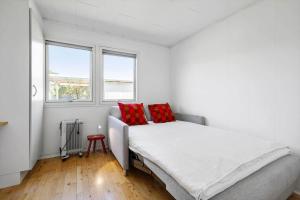 a bedroom with a bed with red pillows on it at SL364-Slagelse-Hirsevangen-4 in Strandlyst