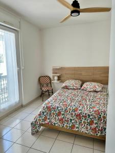 a bedroom with a bed and a ceiling fan at The Rave in Sète