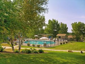 a swimming pool in a park with a yard at Club Wyndham Tamarack in Wisconsin Dells