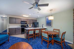 a kitchen and dining room with a table and chairs at Club Wyndham Tamarack in Wisconsin Dells