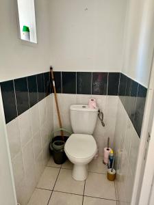 a bathroom with a white toilet in a tiled room at The Rave in Sète +5 photos