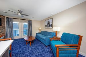 a living room with a blue couch and a table at Club Wyndham Tamarack in Wisconsin Dells