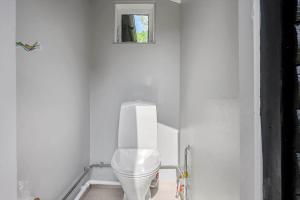 a white bathroom with a toilet in a white wall at SL369-Rude-Hvirvilsvej-4 in Bisserup