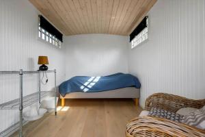 a bedroom with a bed in a room with windows at SL369-Rude-Hvirvilsvej-4 in Bisserup