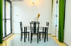 a dining room with a table and chairs at BJ House in Douala +6 photos