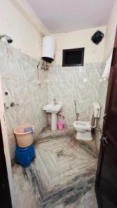 a bathroom with a sink and a toilet at Kamlesh Niwas in Rishīkesh +3 photos
