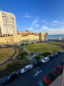a parking lot with cars parked in front of a building at 12A Regency Square in Brighton & Hove