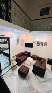 a living room with two couches and a table at Kamlesh Niwas in Rishīkesh