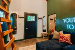 a living room with a couch and a black door at The Taoist 5min to Gorge with Private Cliffs in Rogers