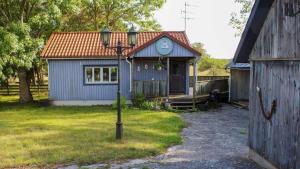 a blue house with a clock on top of it at GOT121-Laerbro-Rute-Sofiero-133 in Lärbro