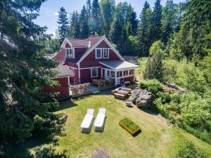 an aerial view of a red house with a yard at VMA812-Kolsva-Lomstigen-7 in Kolsva