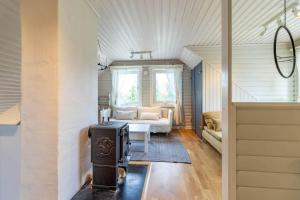 a living room with a stove and a couch at VMA812-Kolsva-Lomstigen-7 in Kolsva