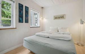 a white room with a bed with white pillows on it at AE329-Aeroskobing-Oster-Bregninge-24 in Ærøskøbing