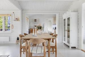 a dining room with a wooden table and chairs at TV1729-Jerup-Engdraget-16 in Bratten Strand