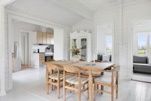 a kitchen and dining room with a wooden table and chairs at TV1729-Jerup-Engdraget-16 in Bratten Strand +20 photos