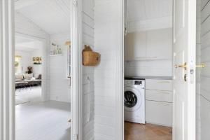 a white laundry room with a washer and dryer at TV1729-Jerup-Engdraget-16 in Bratten Strand