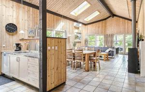 a kitchen and dining room with a table and chairs at Pet Friendly Home In Oksbøl With Sauna in Oksbøl
