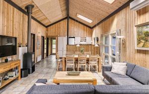 a living room with a couch and a table at Pet Friendly Home In Oksbøl With Sauna in Oksbøl