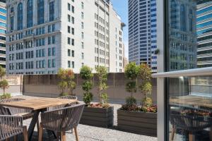 a patio with a table and chairs and buildings at The Westin Minneapolis in Minneapolis