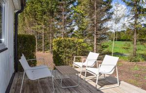 a group of chairs and a table on a porch at Gorgeous Home In Ystad in Ystad