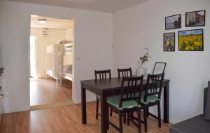 a dining room with a black table and chairs at Gorgeous Home In Ystad in Ystad