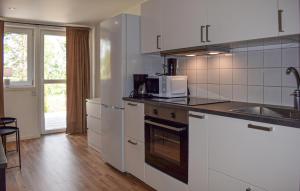a kitchen with white cabinets and a sink at Gorgeous Home In Ystad in Ystad