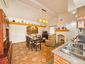 a kitchen and living room with a table and a fireplace at O Rossio in Esperança +27 photos