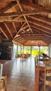 a large room with wooden ceilings and tables and chairs at Cabaña Oasis Ixmiquilpan in Ixmiquilpan