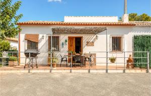 a white house with a porch with a table and chairs at Lovely Home In Abarán in Abarán +14 photos