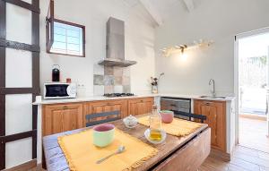 a kitchen with a wooden table with two chairs at Lovely Home In Abarán in Abarán