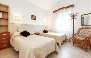 a hotel room with two beds and a chair at Lovely Home In Abarán in Abarán