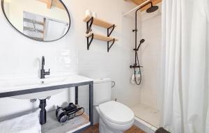 a bathroom with a toilet and a sink and a mirror at Lovely Home In Abarán in Abarán