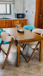 a wooden table and chairs in a kitchen at Zabibu Collection in Arusha