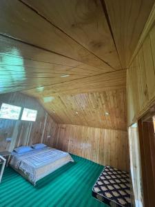 a bedroom with a bed in a wooden room at the jibhi nest cottage in Mandi