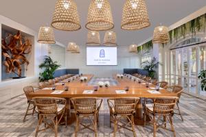 a large table in a room with chairs and chandeliers at Santa Marina, A Luxury Collection Resort, Mykonos in Ornos +178 photos