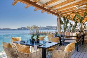 a restaurant with a view of the water at Santa Marina, A Luxury Collection Resort, Mykonos in Ornos