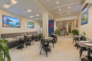 a dining room with tables and chairs in a restaurant at Queen Cafe Hostel in Hanoi