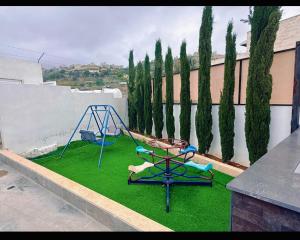 a playground with a swing and a swing at Casablanca chalet in Umm Nūwārah