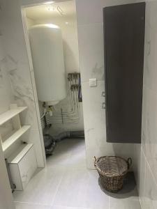 a bathroom with a black cabinet and a basket at Apartment 65 m2 SE Rez de Jardin 2 chambres in Varetz +32 photos